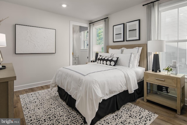 bedroom featuring hardwood / wood-style floors and ensuite bath