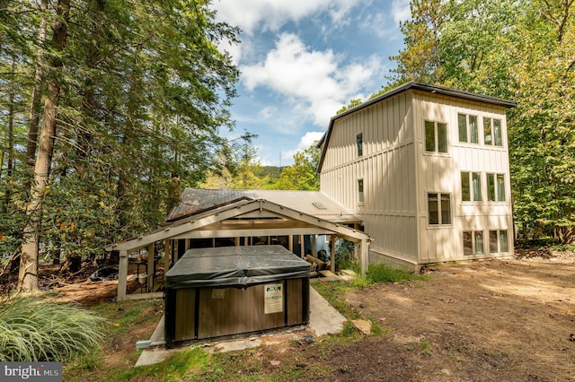 back of house featuring a hot tub