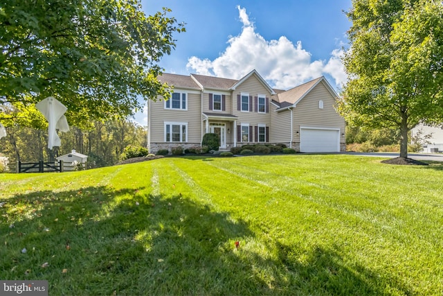 view of front of property with a front yard and a garage