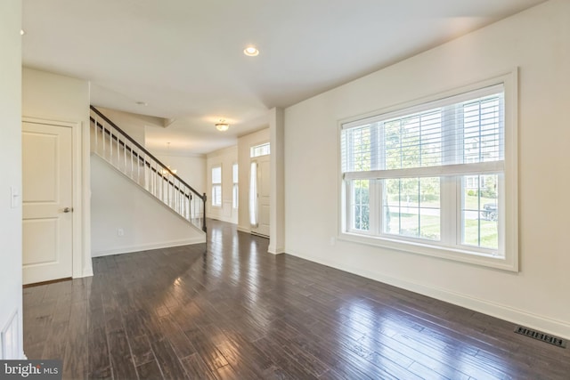 unfurnished living room featuring dark wood-type flooring