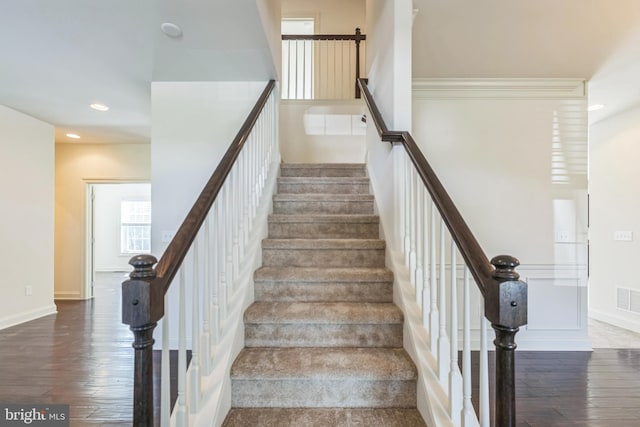 staircase featuring wood-type flooring