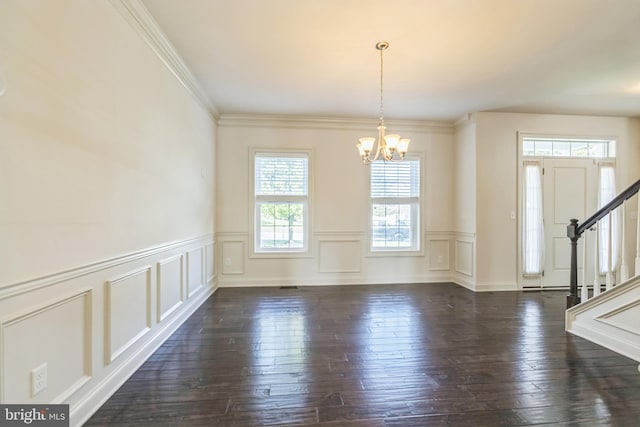 unfurnished dining area with a notable chandelier, plenty of natural light, dark hardwood / wood-style floors, and crown molding