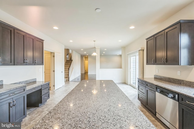 kitchen featuring dark brown cabinetry, decorative light fixtures, dishwasher, and light stone countertops