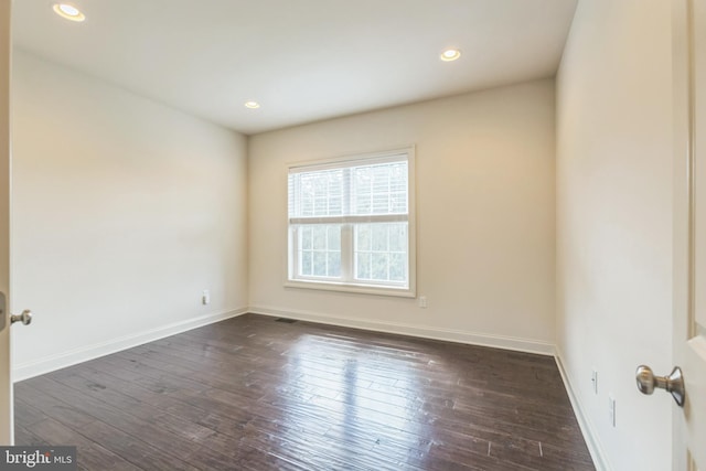 unfurnished room featuring dark wood-type flooring