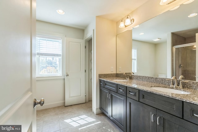 bathroom with vanity, a shower with shower door, and tile patterned flooring