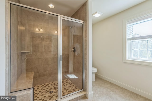 bathroom featuring toilet, an enclosed shower, and tile patterned floors