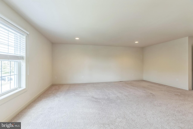 carpeted spare room featuring a healthy amount of sunlight