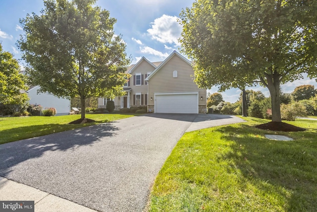 view of front of property with a front yard and a garage