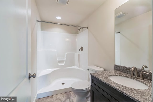 bathroom with a shower, vanity, and toilet