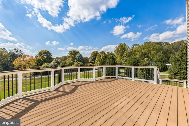 wooden deck with a lawn