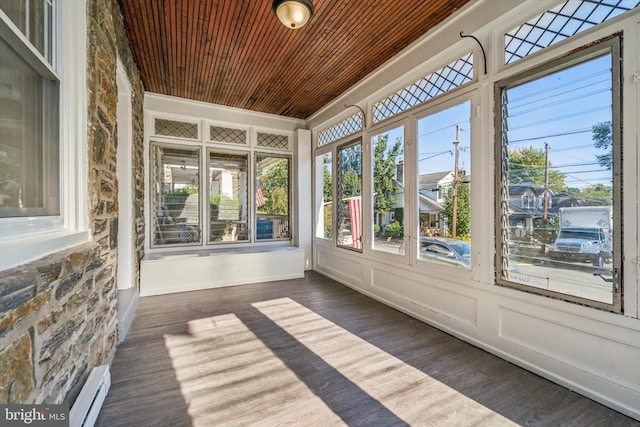 unfurnished sunroom featuring baseboard heating and wooden ceiling