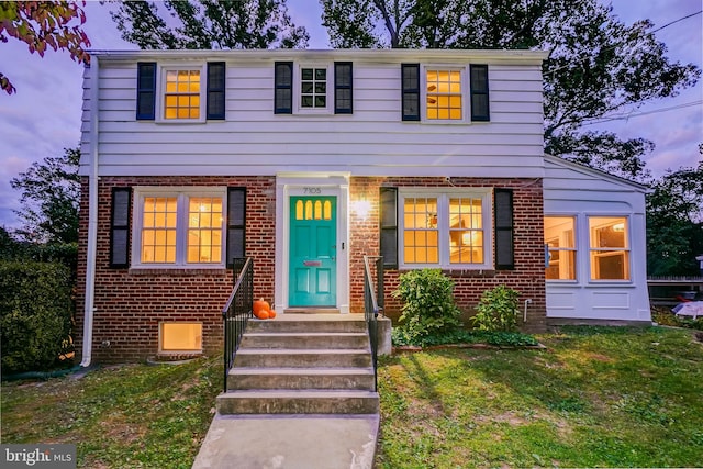 view of front of home with a yard