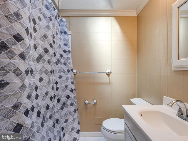 bathroom with tile walls, vanity, curtained shower, crown molding, and toilet