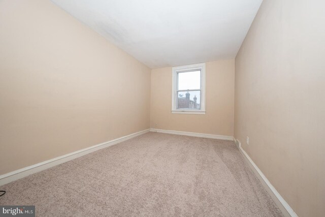 empty room with carpet flooring and baseboards