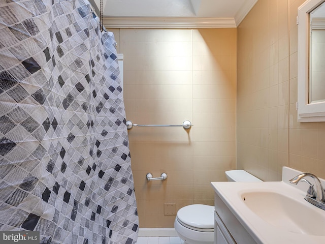 bathroom with toilet, vanity, crown molding, curtained shower, and tile walls