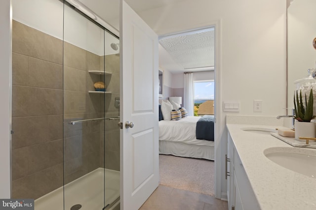 bathroom featuring tile patterned flooring, vanity, and a shower with shower door