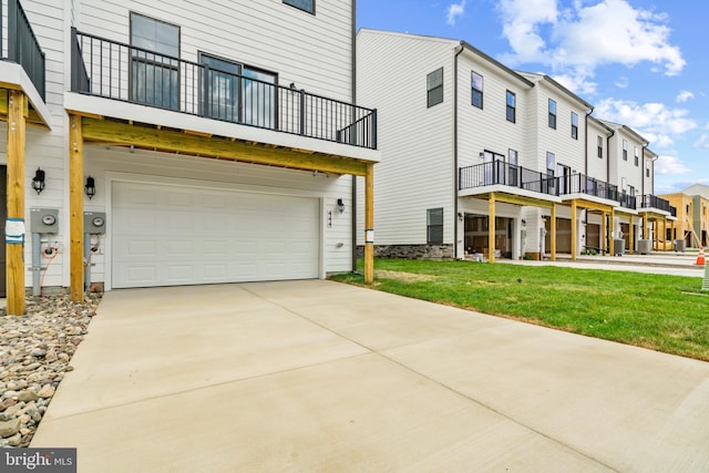 exterior space with a yard, a balcony, and a garage