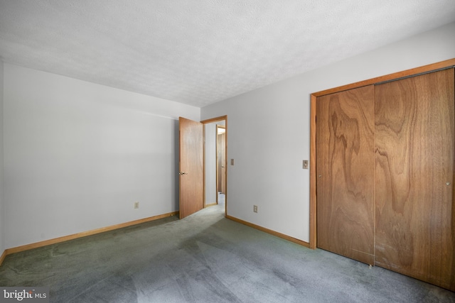 unfurnished bedroom with a closet, carpet flooring, and a textured ceiling