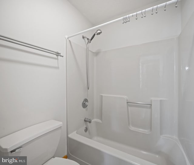 bathroom with washtub / shower combination and toilet