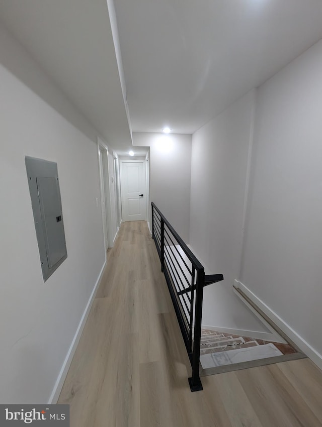 hall featuring light hardwood / wood-style flooring and electric panel