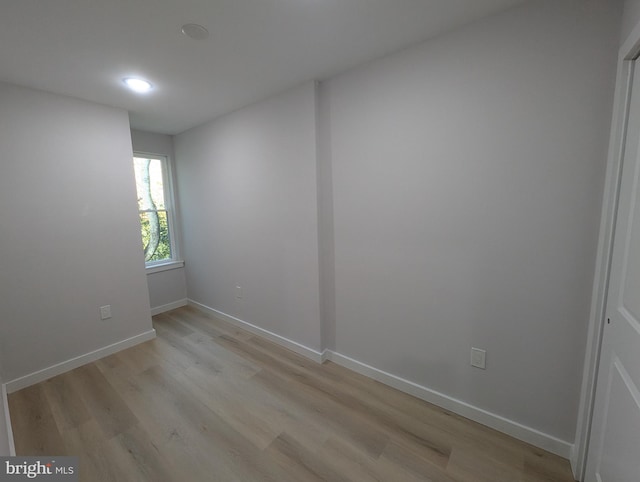 empty room with light hardwood / wood-style flooring