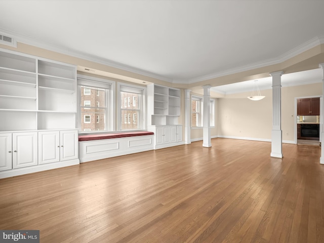 unfurnished living room featuring visible vents, light wood-style flooring, crown molding, decorative columns, and baseboards