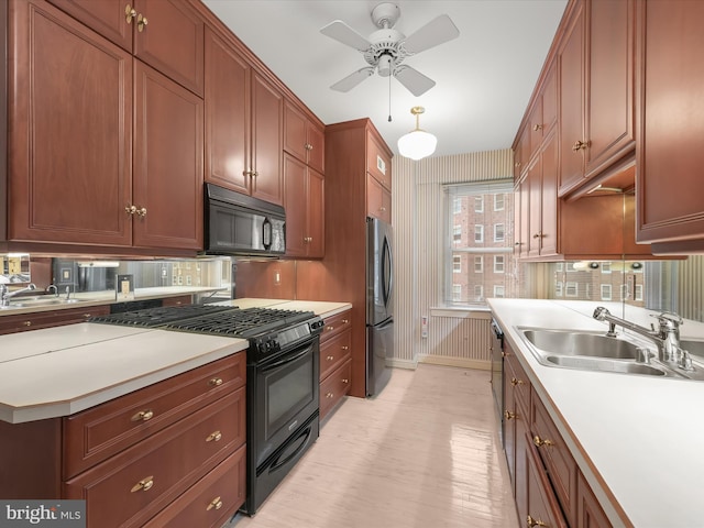 kitchen featuring decorative backsplash, black appliances, light countertops, and a sink