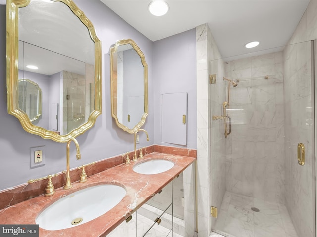 full bathroom featuring double vanity, recessed lighting, a stall shower, and a sink