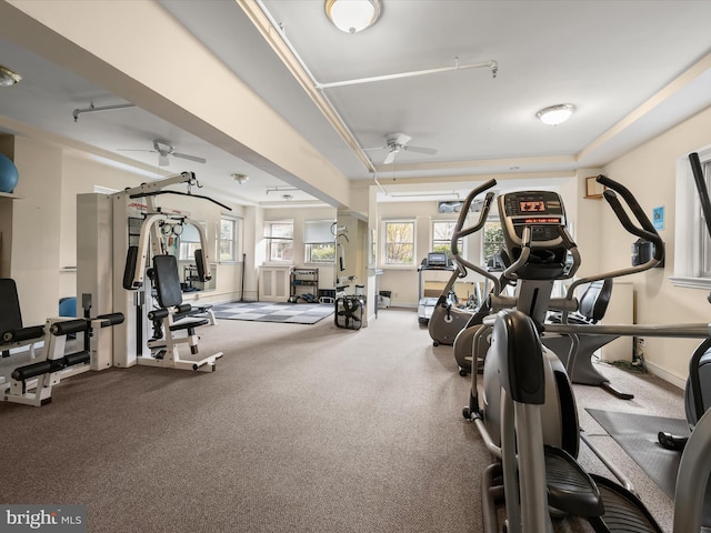 exercise room featuring baseboards and ceiling fan