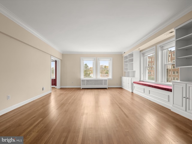 unfurnished living room featuring light wood-type flooring, visible vents, radiator, crown molding, and baseboards