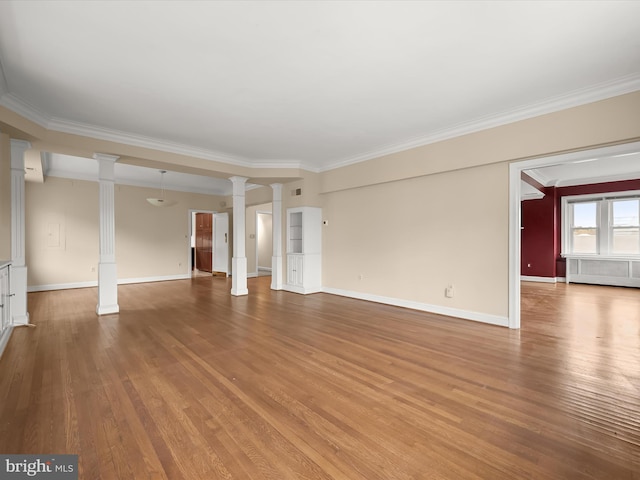 unfurnished living room featuring wood finished floors, baseboards, ornate columns, and ornamental molding