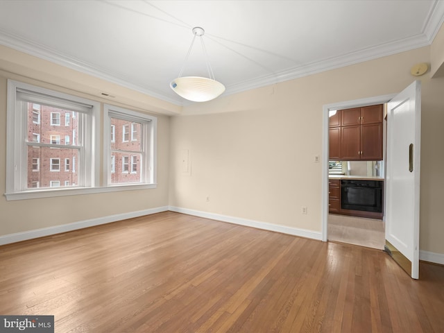 unfurnished dining area with baseboards, light wood-style floors, and crown molding