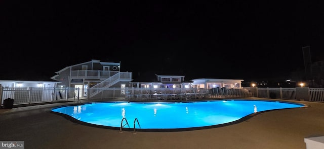 pool at night with a patio