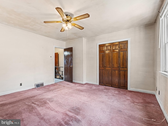 unfurnished bedroom featuring a closet, ceiling fan, and carpet flooring