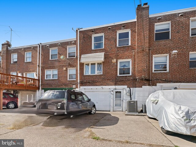 exterior space featuring central AC and a garage