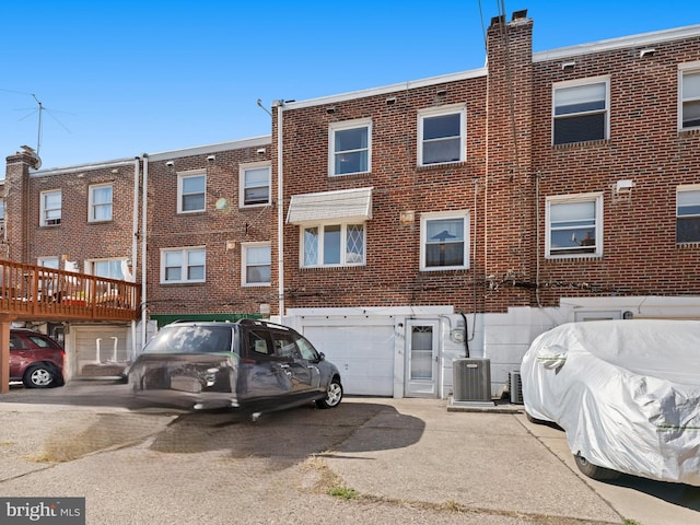 exterior space featuring central AC unit and a garage