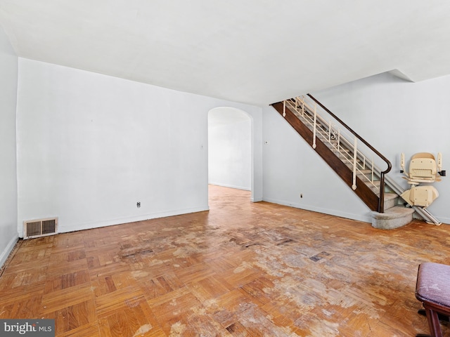 unfurnished living room with parquet floors