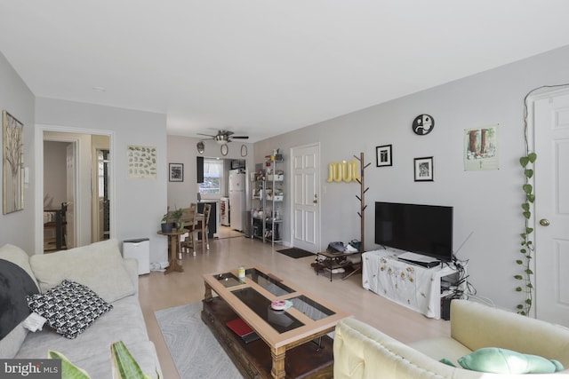 living room featuring hardwood / wood-style flooring and ceiling fan