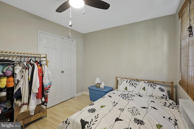 bedroom with ceiling fan, hardwood / wood-style flooring, and a closet