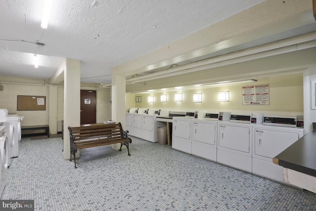 washroom with separate washer and dryer and a textured ceiling