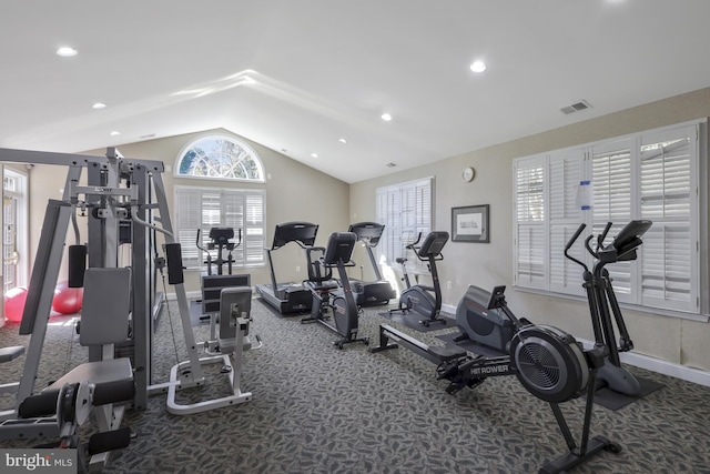 workout area featuring lofted ceiling and carpet