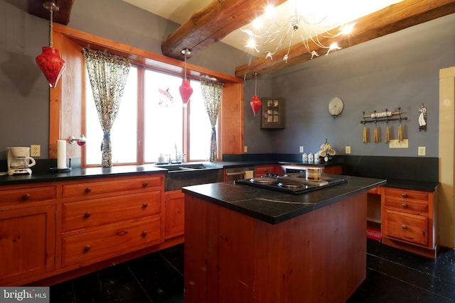 kitchen featuring sink, pendant lighting, dark tile patterned floors, and a chandelier