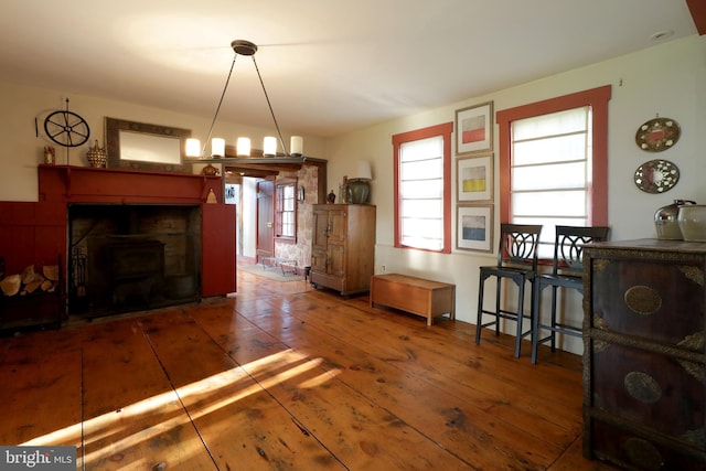 dining space featuring dark hardwood / wood-style floors and a wood stove