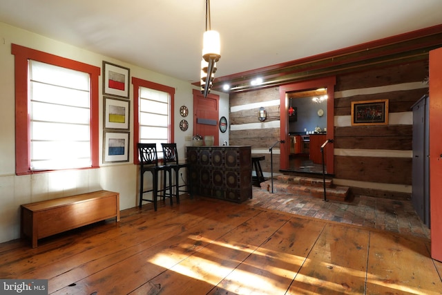 interior space featuring wood walls and dark wood-type flooring