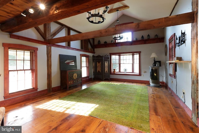 interior space featuring beamed ceiling, plenty of natural light, and hardwood / wood-style floors