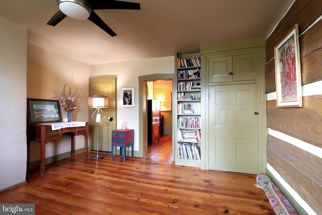 interior space featuring wood-type flooring and ceiling fan