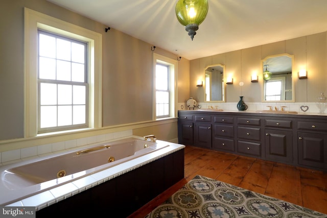 bathroom with vanity, a bath, and hardwood / wood-style floors