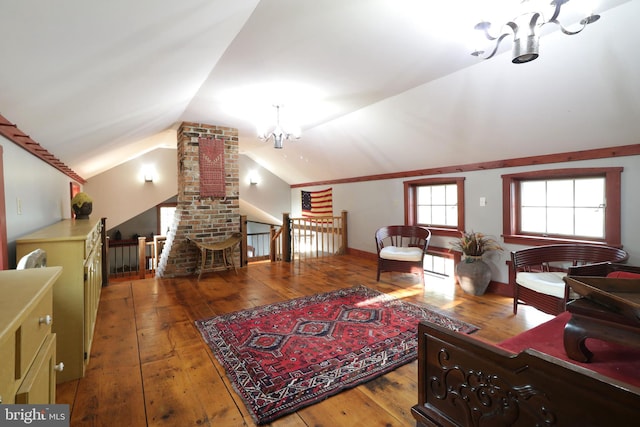 living room with vaulted ceiling, a chandelier, and hardwood / wood-style flooring