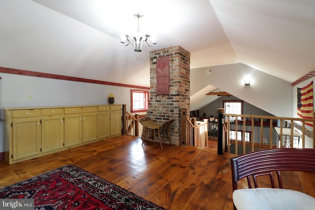 interior space featuring an inviting chandelier, lofted ceiling, and dark hardwood / wood-style flooring