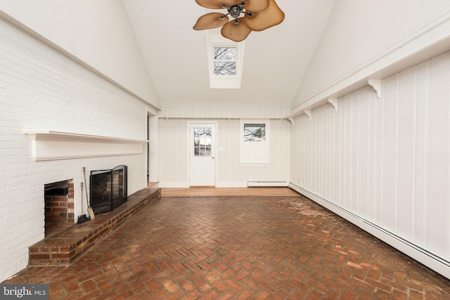 unfurnished living room with ceiling fan, high vaulted ceiling, a brick fireplace, and a baseboard heating unit